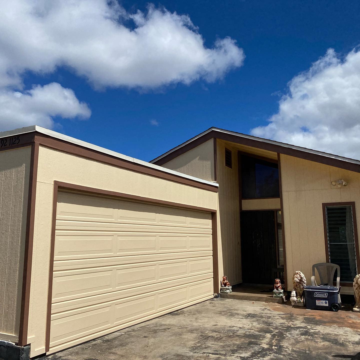 Cream stucco home with brown trim and double garage