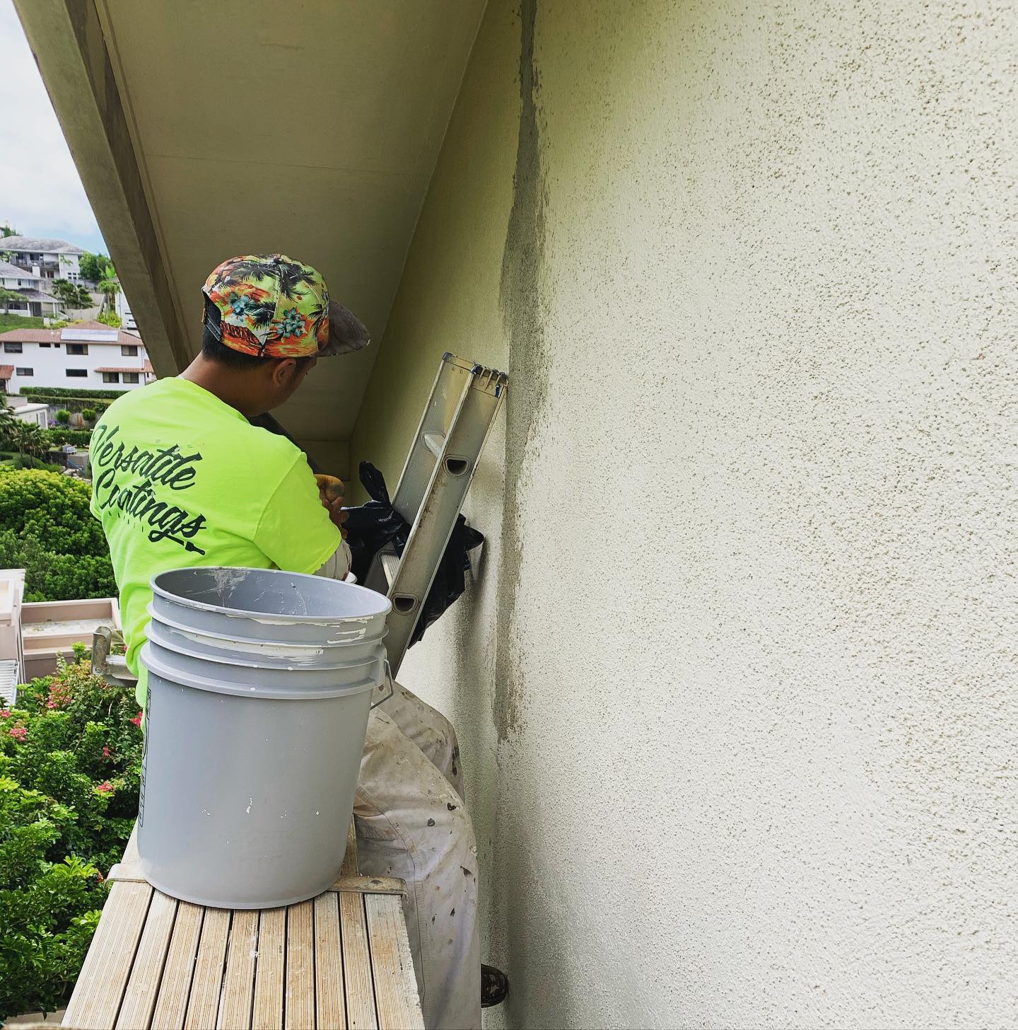 Versatile Coatings Hawaii crew prepping a stucco lanai before painting